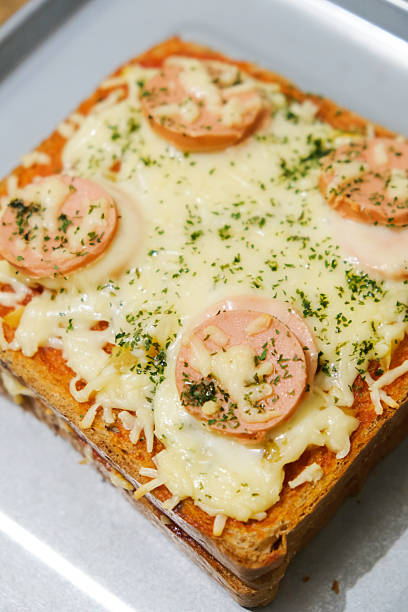 istock Homemade pizza made from white bread with sausage and cheese toppings 2226956520