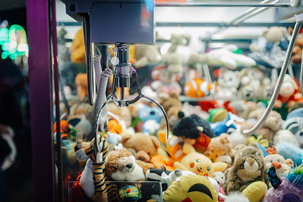 istock Claw crane picking up plush toys in arcade game machine 2226956544