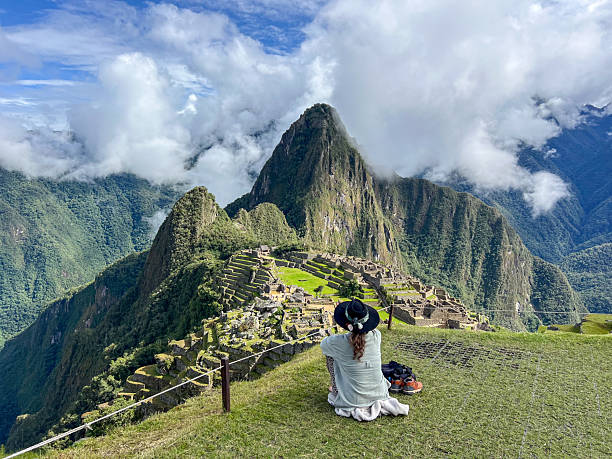istock Woman Sitting Overlooking Machu Picchu Ruins 2226956576