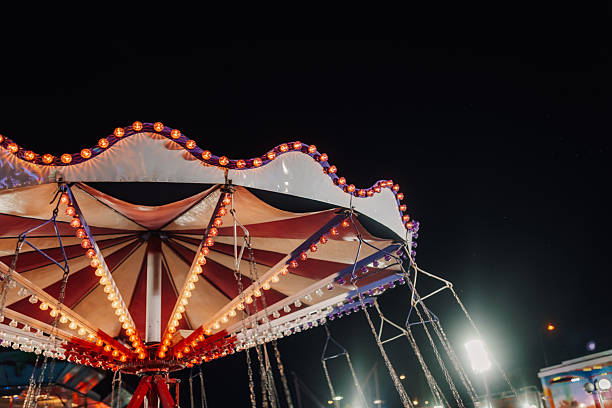 istock Swing ride canopy illuminated at night in amusement park 2226956602