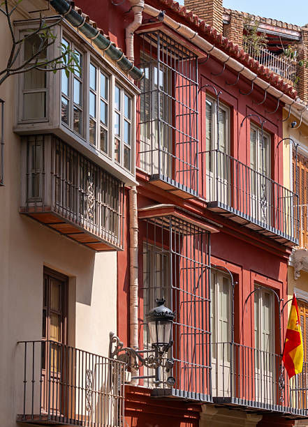 Facade of apartments with balconies, conservatories and shutters in the center of Málaga in Spain.