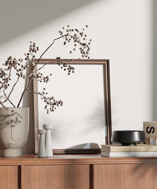 3D rendering of a modern minimalist interior featuring a vertical poster frame mockup on a wooden sideboard. Styled with Japandi home decor, natural light, and neutral tones—perfect for showcasing artwork, printable designs, or wall posters.