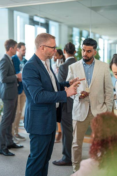 istock Business Colleagues Engaging in Conversation During Office Celebration 2226961147