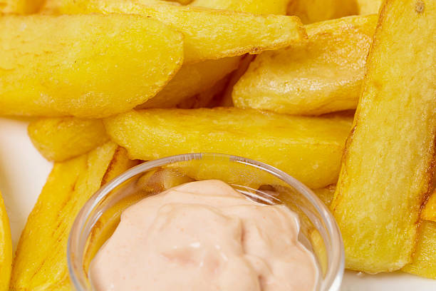 Delicious potato wedges with sauce. Fast food. Can be used as a whole background.