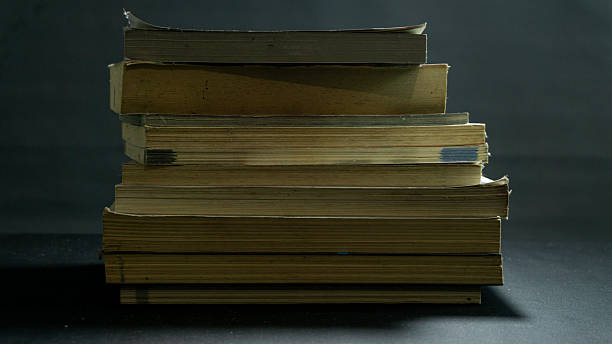 istock Neatly stacked books against black background, clean and organized composition with academic, educational, or minimal editorial concept 2226963616