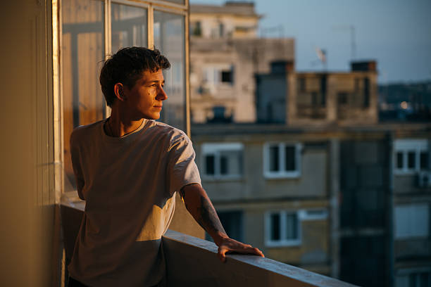 istock Man enjoying sunset on his balcony 2226964565