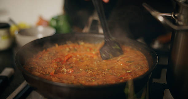 istock Hands, chef and sauce for meal, pan and preparation for dinner in kitchen, catering and culinary skills. Cooking, cuisine and person with food for supper, seasoning and mixing ingredients for flavor 2226965373