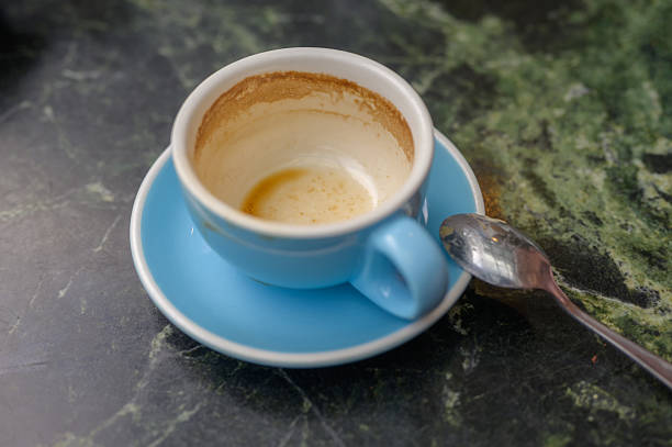Two used cappuccino cups are on a wooden kitchen counter. Love and togetherness concept without people.