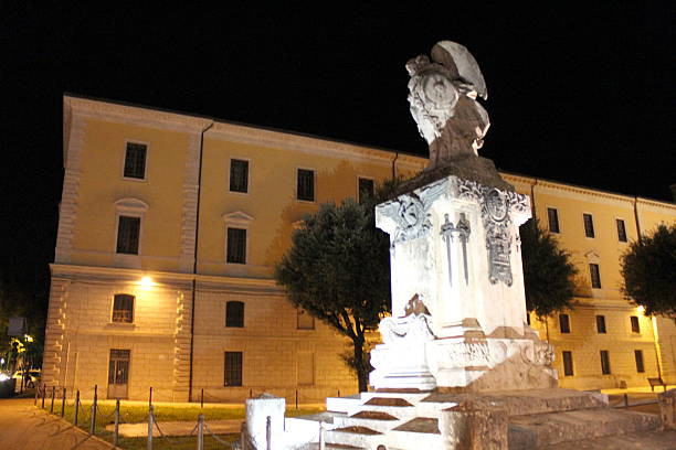 Rieti, Italy - October 16th 2017: Majestic War Memorial statue bathed in warm light in Rieti, Italy, at night (Photo by Dadada)