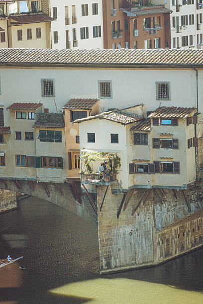 A scenic view of the Ponte Vecchio medieval stone bridge in Florence, Italy.