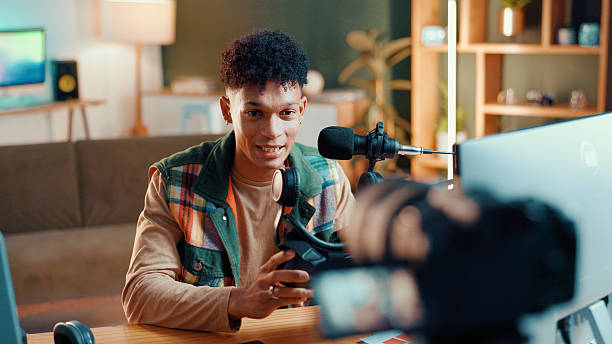 istock Man, influencer and online streaming with video camera for gaming tips, tutorial or live recording. Male person, podcaster or gamer guide with vr goggles or technology for vlog or review at home 2226973866