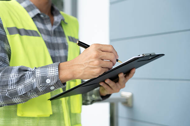 istock inspector or engineer is inspecting construction and quality assurance new house using a checklist. Engineers or architects or contactor work to build the house before handing it over to the homeowner 2226973881