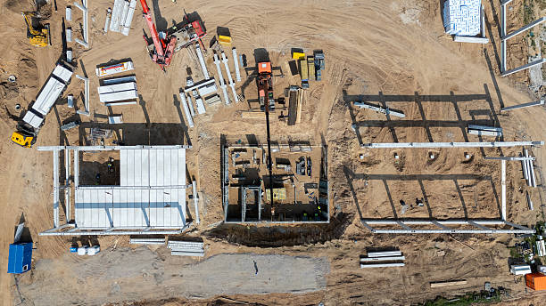 istock Aerial View of Active Construction Site with Cranes and Workers 2226975427