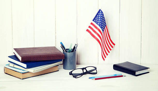 istock The USA flag on the desktop. Education concept. 2226976765