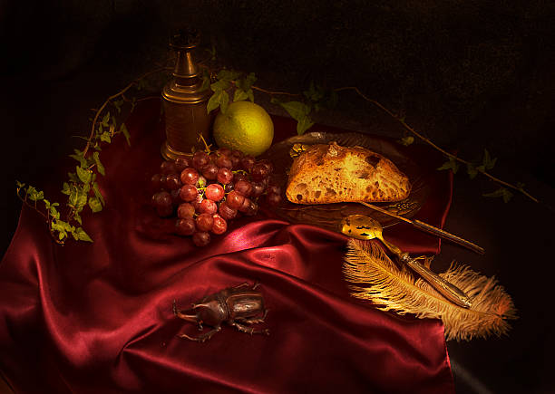 istock Baroque still life with red grapes, rustic bread and lemon on a maroon satin fabric 2 2226978837
