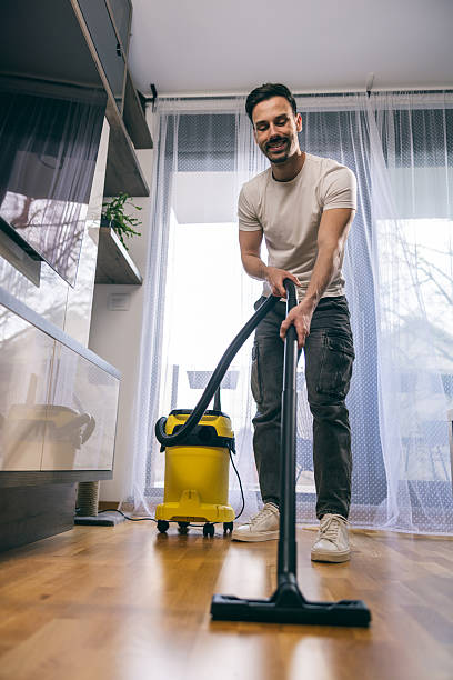 istock Man Vacuuming His Home 2226978905