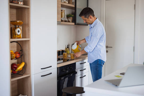 istock Man pouring hot water into cup in modern kitchen 2226983490