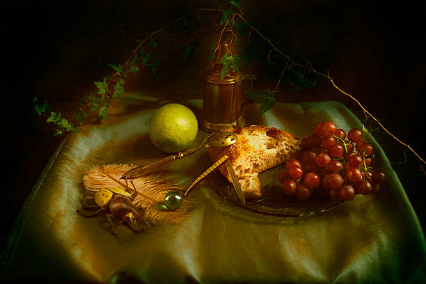 istock Baroque still life with red grapes, rustic bread and lemon on a green satin fabric 2226983758