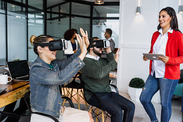 istock Group of young latin business people using virtual reality glasses during meeting testing VR headset at office in Mexico Latin America. hispanic people at working at job 2226983785