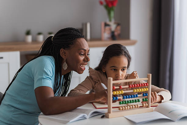 istock Mother helping daughter with homework using abacus at home 2226986387