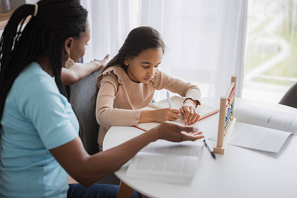 istock Young girl learning numbers with teacher using abacus at home 2226986417