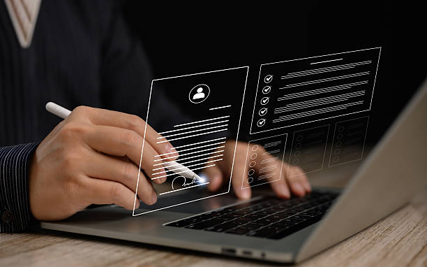 istock Recruiter selecting a digital resume from multiple candidate profiles using a stylus on a virtual screen. Ideal for HR tech, job application systems, and modern recruitment workflows. 2226988167