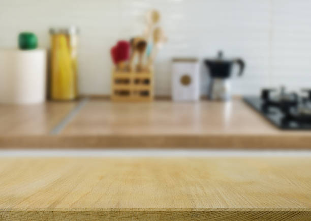 istock Wooden  table top on blur kitchen counter room background 2226988238