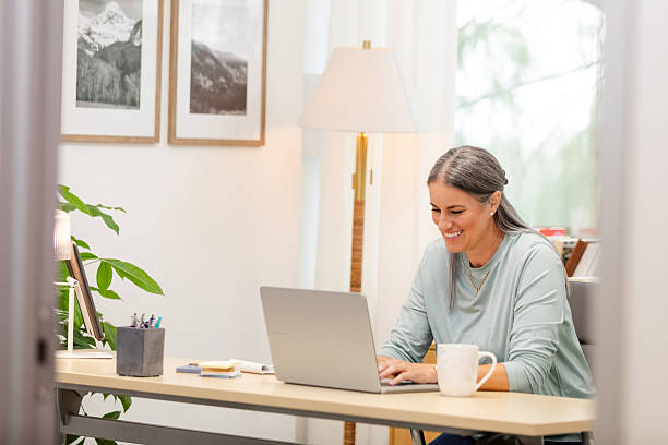 istock Smiling Woman Working on Laptop in Home Office 2226988995