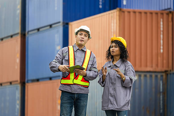 istock Team of Engineer and foreman worker in hardhat and safety vest checking containers box from cargo, Teamwork concepts 2226991724