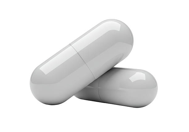 istock Isolated Pair of White Capsule Pills 2226994307