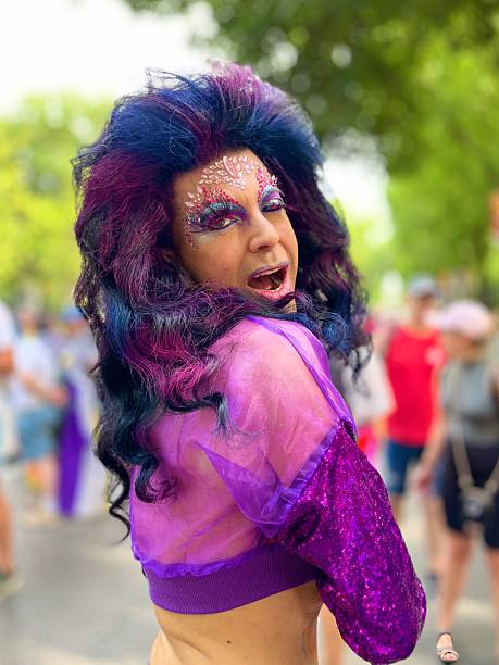 Madrid, Spain - July 5, 2025: Vibrant participant at Madrid Gay Pride, displaying colorful makeup and a dazzling outfit, embodies diversity, acceptance, and joy in the heart of the celebration.