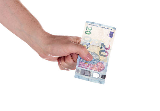 Man's hand holds twenty euros banknotes. 20 euro currency.