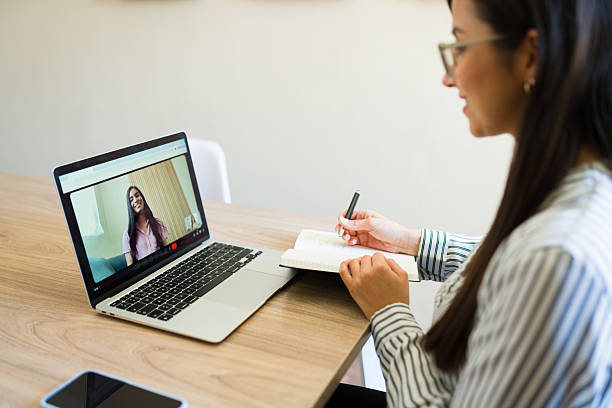 istock Psychologist taking notes during online therapy session with patient on laptop 2226997534