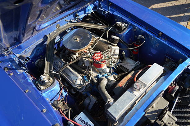 Blue classic muscle car, Open hood close up on red engine, Big chrome round air intake filter, tubes, wires, pipes, brake vacuum servo, other parts