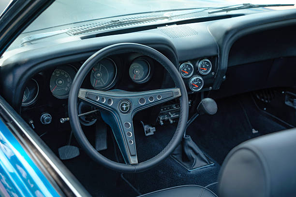 Close-up of classic 1969 Ford Mustang interior with original steering wheel, vintage dashboard and aftermarket gauges. Manual transmission. June 7, .2025, Palic Serbia