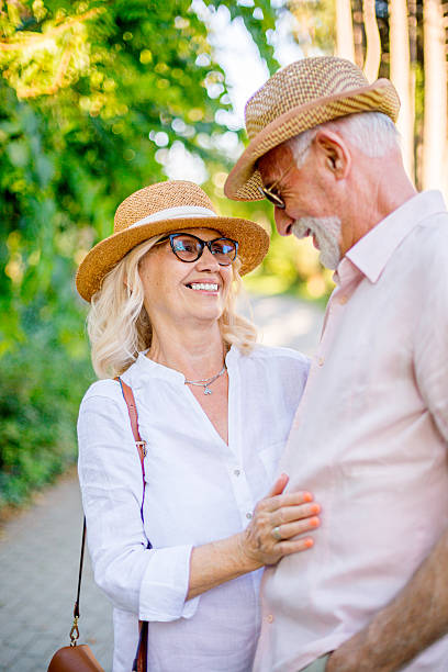 istock Happy senior couple enjoying a walk in the park 2227000708