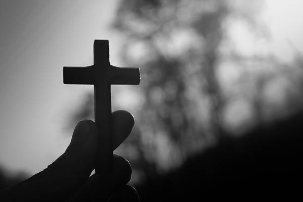 istock cross in the hand against the backdrop of nature 2227006830