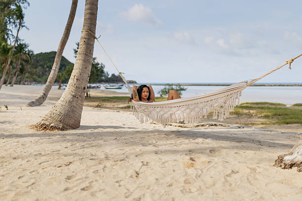 istock Woman relaxing in hammock on tropical beach 2227008592
