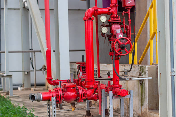 istock Complex industrial red pipe system with valves and gauges for water supply and safety regulations 2227009711