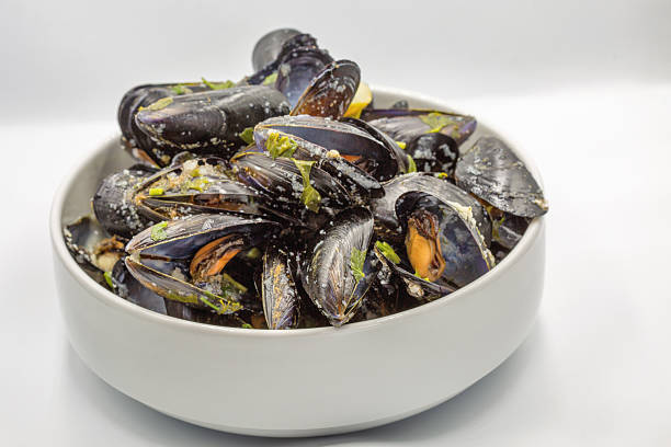 istock Steamed mussels in white wine and herbs closeup. 2227009843