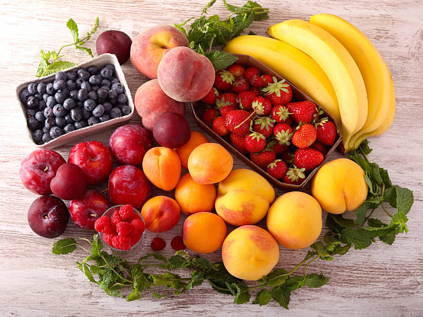 Assorted fresh fruits and berries on table