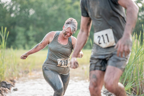 istock Participants Engage in Mud Run Competition in Natural Outdoor Environment 2227010582