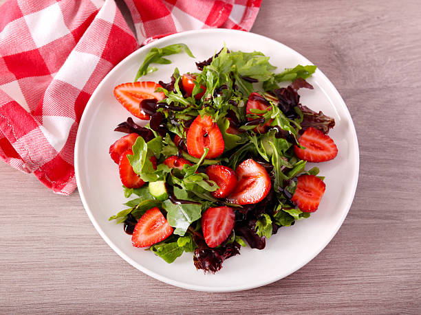 istock Green salad with strawberry and balsamic on plate 2227010757