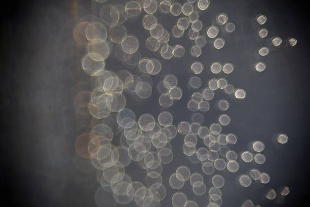 Conceptual and artistic image displaying a blurred bokeh texture with circular light orbs creating an abstract scene, evoking serenity in a dimly lit atmospheric setting.