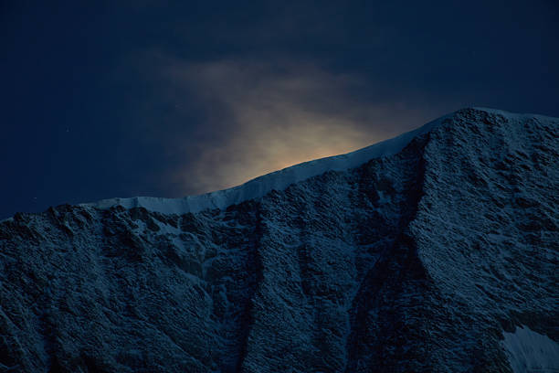 istock Illuminated Mountain Peak During a Nighttime Sky With Glowing Light 2227012799