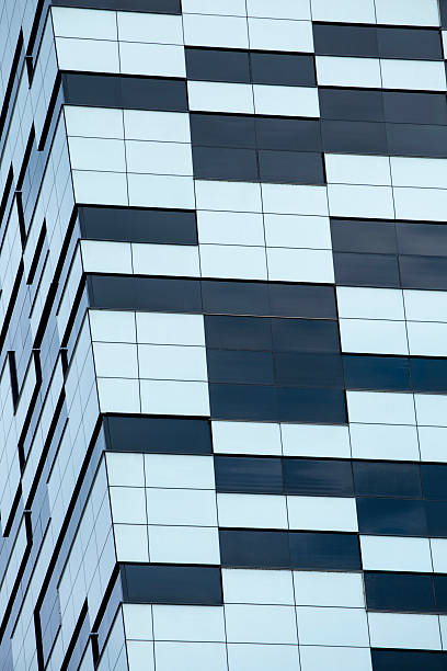 istock Modern Building with Mixed Facade: Glass Panels and Geometric Cladding 2227015862