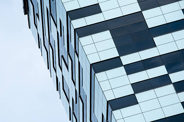 istock Modern Building with Mixed Facade: Glass Panels and Geometric Cladding 2227015878