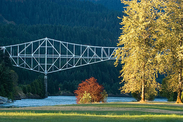 Steel truss cantilever Bridge of the Gods spanning Columbia River in Cascade Locks during foliage, Oregon, USA