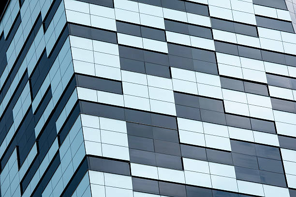 istock Modern Building with Mixed Facade: Glass Panels and Geometric Cladding 2227016076