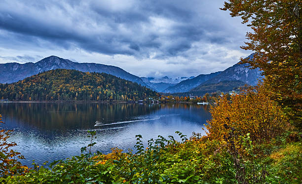 istock Serene Mountain Lake With Autumn Forest Reflection Under Cloudy Sky 2227017705